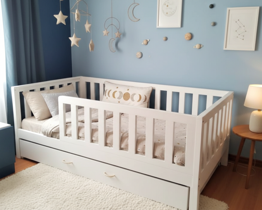 White crib with bedding in a room with blue walls, decorative items, and a lamp.