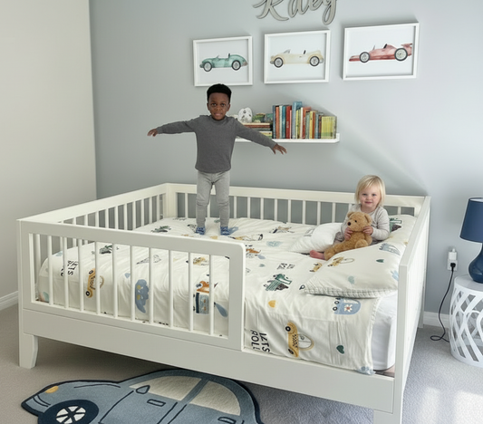 Children playing in a crib with toys in a room with a bookshelf and lamp.