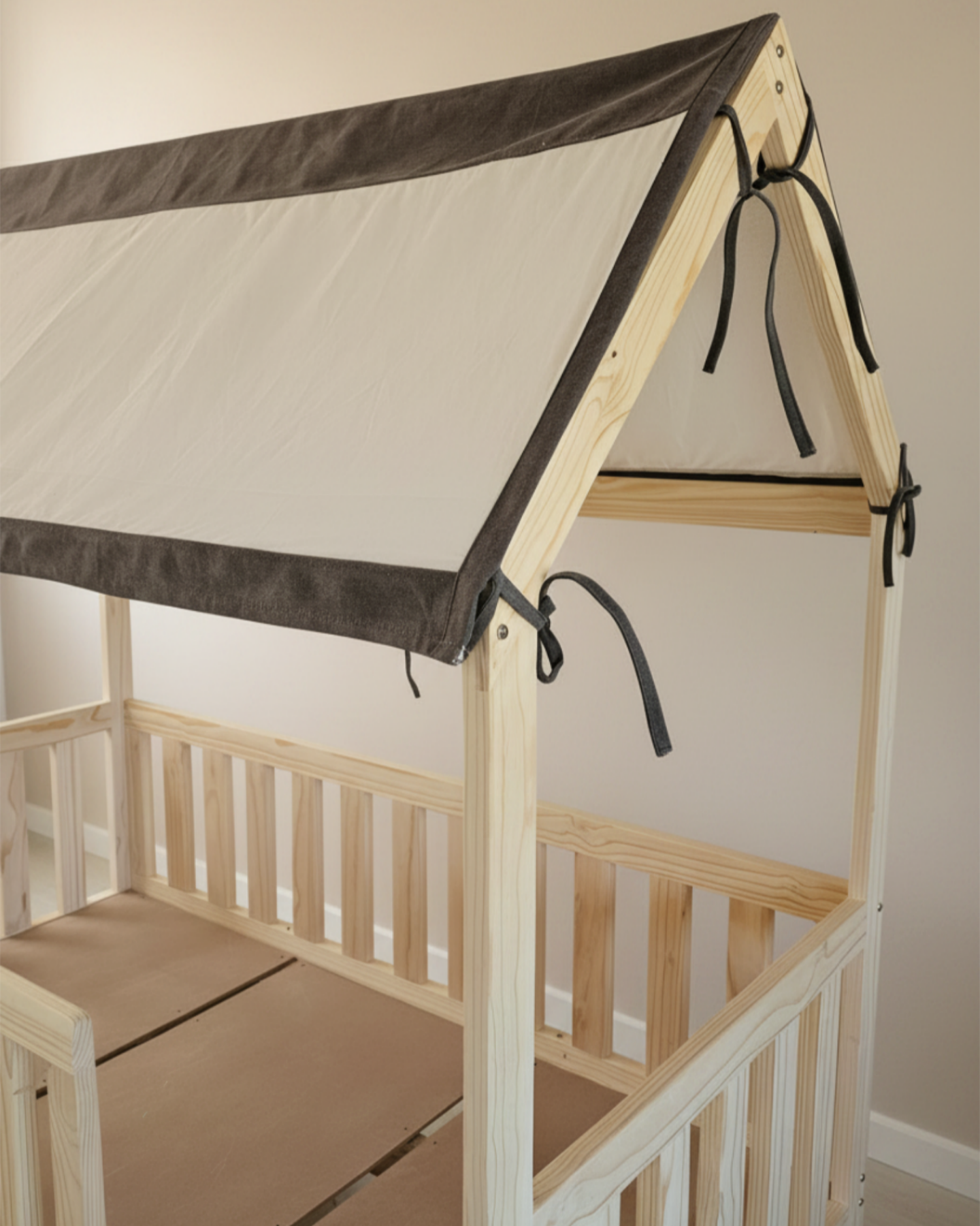 Wooden children's bed with a canopy in a neutral setting