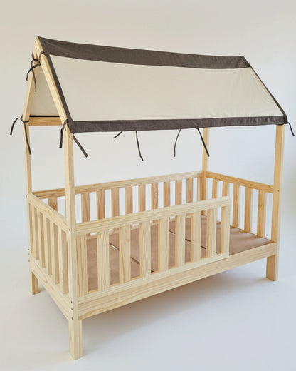 Wooden crib with a beige roof and brown trim on a white background