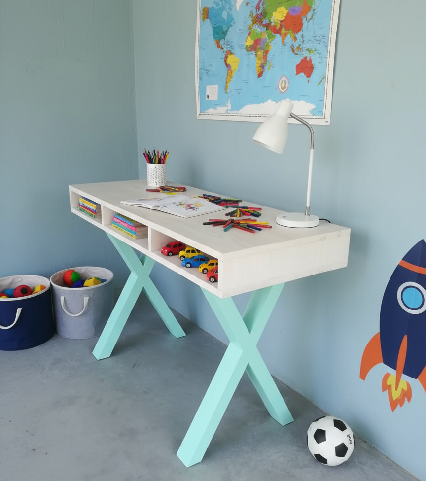 Children's desk with toys and a world map on the wall in a playroom.